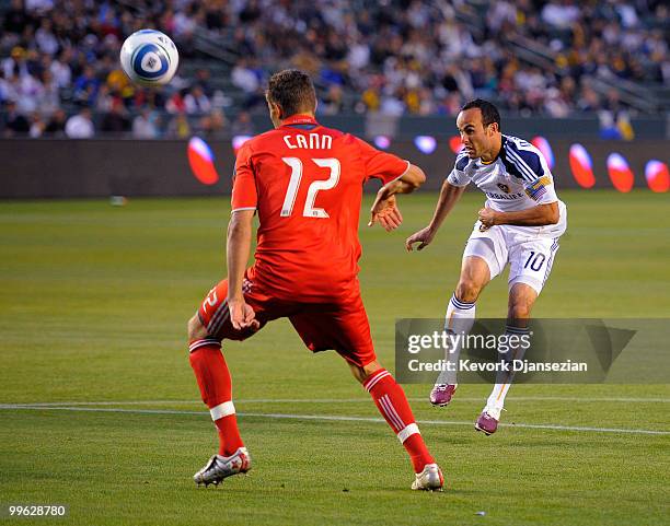 Landon Donovan of the Los Angeles Galaxy takes a shot on goal as Adrian cann of Toronto FC defends during the first half of the MLS soccer match on...