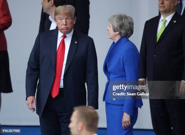 President Donald Trump and British Prime Minister Theresa May attend the opening ceremony at the 2018 NATO Summit at NATO headquarters on July 11,...