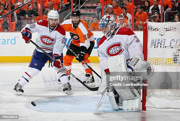 Josh Gorges and goaltender Carey Price of the Montreal Canadiens defend against the attack of Ville Leino of the Philadelphia Flyers in Game One of...