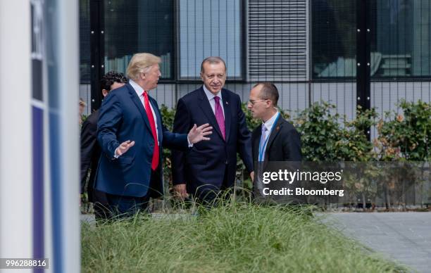 President Donald Trump, left, walks with Recep Tayyip Erdogan, Turkey's president, ahead of a family photo gathering at the North Atlantic Treaty...