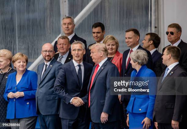 Jens Stoltenberg, secretary general of the North Atlantic Treaty Organization , center left, and U.S. President Donald Trump, center right, shake...