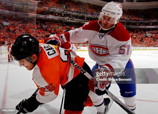 Benoit Pouliot of the Montreal Canadiens checks Matt Carle of the Philadelphia Flyers into the boards in Game 1 of the Eastern Conference Finals...