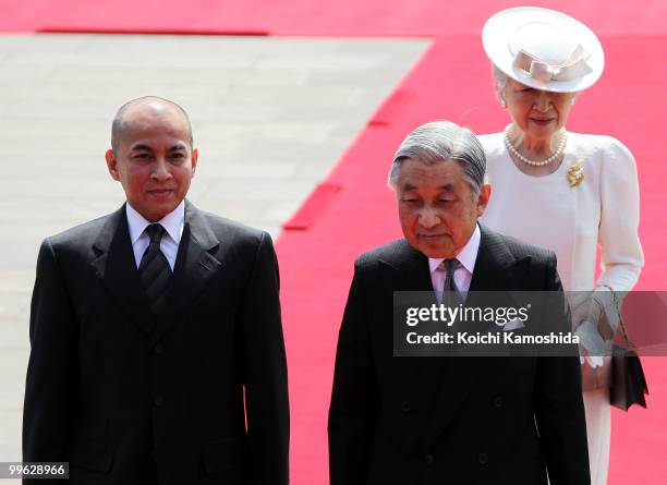 King Norodom Sihamoni of Cambodia is escorted by Japanese Emperor Akihito and Empress Michiko during his welcoming ceremony at the Imperial Palace on...