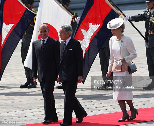 King Norodom Sihamoni of Cambodia is escorted by Japanese Emperor Akihito and Empress Michiko during his welcoming ceremony at the Imperial Palace on...