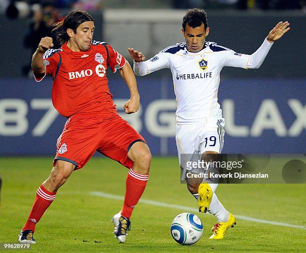 Juninho of Los Angeles Galaxy in action against Nick Garcia of Toronto FC during the second half of the MLS soccer game on May 15, 2010 at the Home...