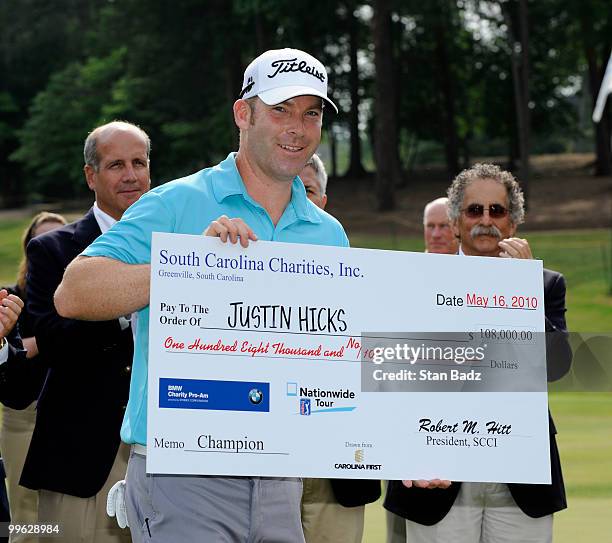 Justin Hicks holds his winner's check on the 18th green after the final round of the BMW Charity Pro-Am presented by SYNNEX Corporation at the...