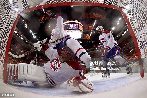 Travis Moen of the Montreal Canadiens gets tangled up with Jaroslav Halak against the Philadelphia Flyers in Game 1 of the Eastern Conference Finals...