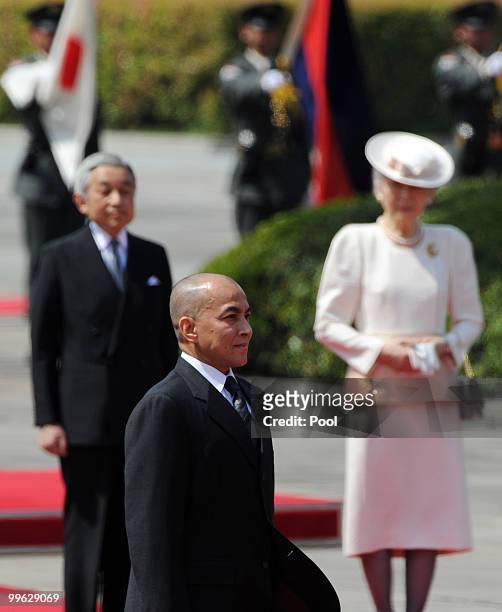 King Norodom Sihamoni of Cambodia walks before Japanese Emperor Akihito and Empress Michiko during his welcoming ceremony at the Imperial Palace on...