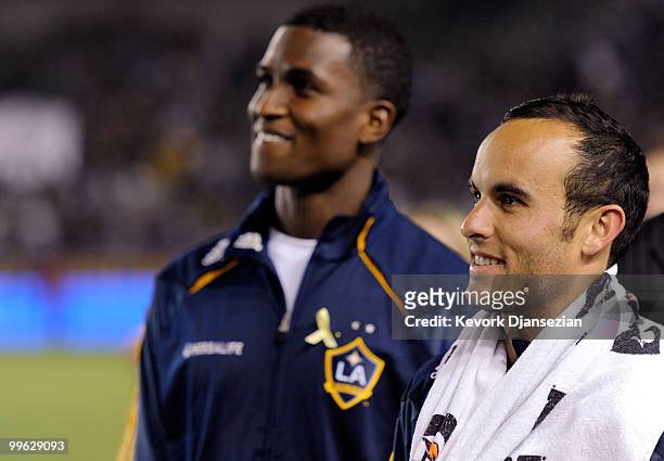 Landon Donovan and Edson Buddle of the Los Angeles Galaxy look at the stadium screen during a World Cup send off ceremony for them after the MLS...
