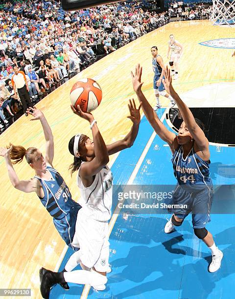 Rahsanda McCants of the Minnesota Lynx goes to the basket against Chasity Melvin of the Washington Mystics during the 2010 season home opening game...