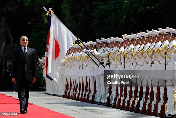 King Norodom Sihamoni of Cambodia reviews a guard of honor during a welcoming ceremony at the Imperial Palace on May 17, 2010 in Tokyo, Japan....