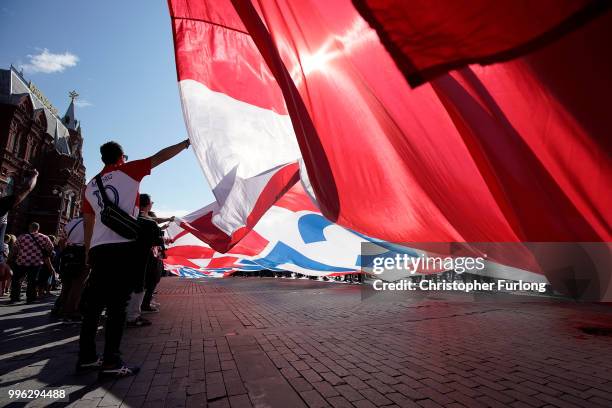 Croatian football fans wave a giant Croatian flag near Red Square ahead of tonight's World Cup semi-final game between England and Croatia on July...