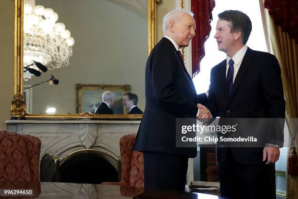 Senate Finance Committee Chairman Orrin Hatch greets Judge Brett Kavanaugh before a meeting in the Senate President pro tempore office at the U.S....