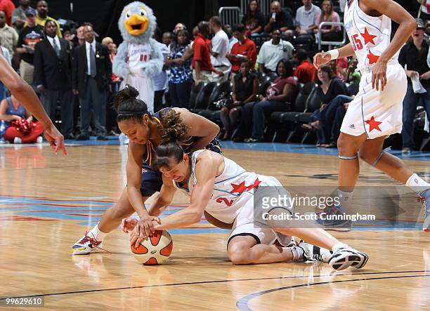 Kelly Miller of the Atlanta Dream battles for a loose ball against Briann January of the Indiana Fever at Philips Arena on May 16, 2010 in Atlanta,...