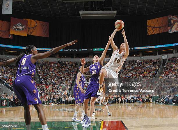 Sue Bird of the Seattle Storm shoots against Ticha Penicheiro and Delisha Milton-Jones of the Los Angeles Sparks on May 16, 2010 at Key Arena in...