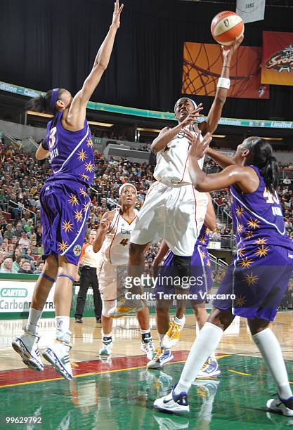 Swin Cash of the Seattle Storm shoots against Noelle Quinn and Candace Parker of the Los Angeles Sparks on May 16, 2010 at Key Arena in Seattle,...