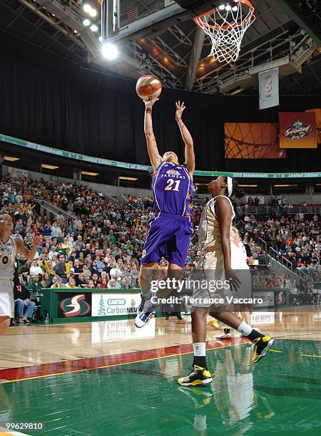 Ticha Penicheiro of the Los Angeles Sparks goes to the basket against Camille Little of the Seattle Storm on May 16, 2010 at Key Arena in Seattle,...