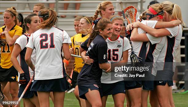Bailey Fogarty and Molly McClintic of the Virginia Cavaliers celebrate their win with teammates against the Towson Tigers at Klockner Stadium May 16,...