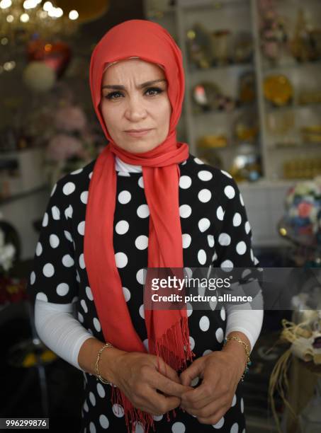 July 2018, Germany, Cologne: Meral Sahin, spokesperson of the IG Keuptstrasse , stands inside her shop on the day of the pronouncement of judgement...