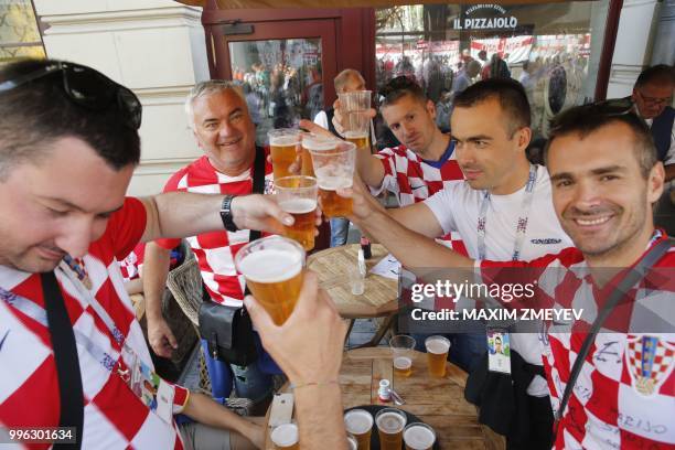 Croatia's supporter drink beers in Moscow on July 11, 2018 ahead of the the semi-final match England v Croatia during the Russia 2018 World Cup...