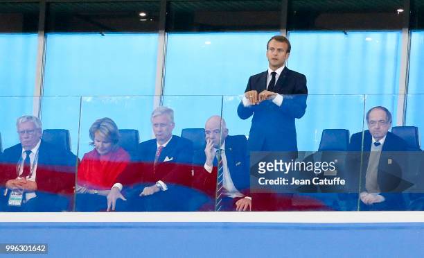 President of France Emmanuel Macron stands while King Philippe of Belgium, Queen Mathilde of Belgium, FIFA President Gianni Infantino, President of...