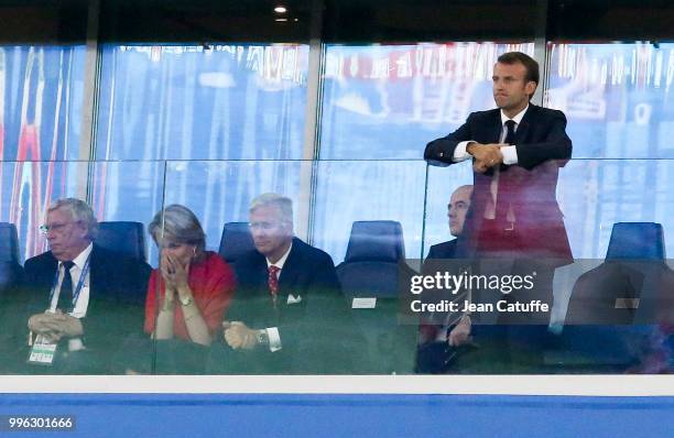 President of France Emmanuel Macron stands while King Philippe of Belgium and Queen Mathilde of Belgium look on during the 2018 FIFA World Cup Russia...