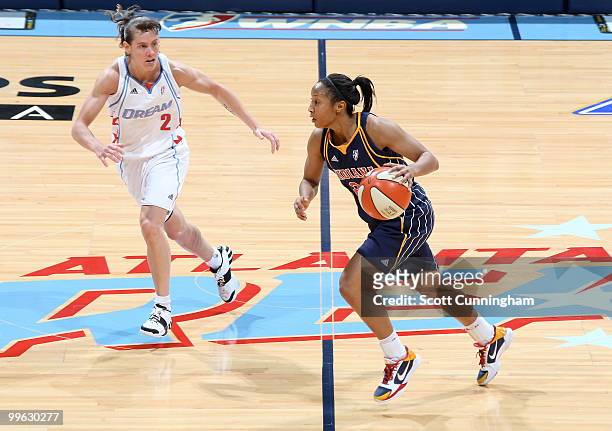 Briann January of the Indiana Fever drives against Kelly Miller of the Atlanta Dream at Philips Arena on May 16, 2010 in Atlanta, Georgia. NOTE TO...