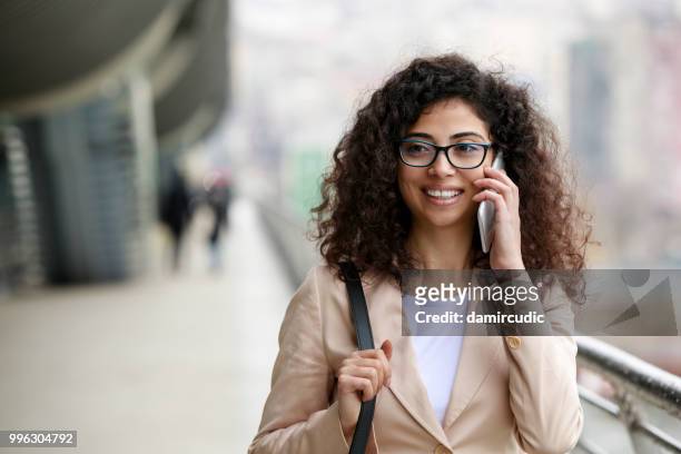 young businesswoman commuting to work - damircudic stock pictures, royalty-free photos & images