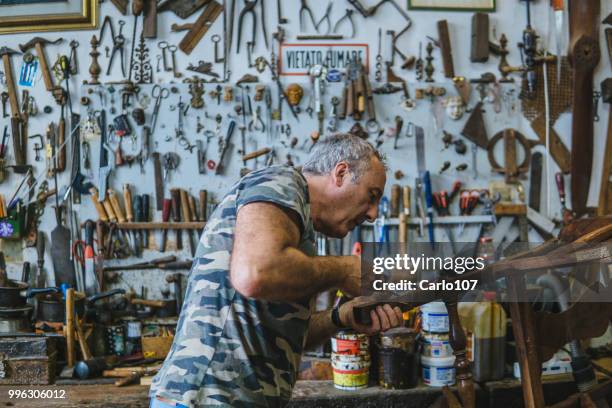 timmerman herstel van een oude houten stoel - carlo107 stockfoto's en -beelden