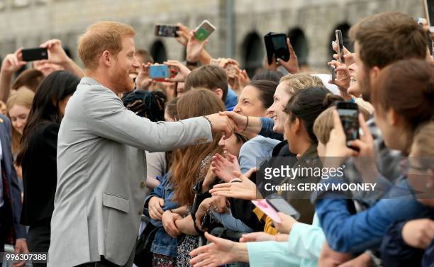 Britain's Prince Harry, Duke of Sussex greets well-wishers after her visit with Britain's Meghan, Duchess of Sussex to Trinity College in Dublin on...