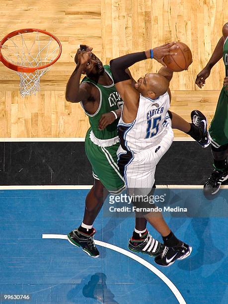 Vince Carter of the Orlando Magic takes the ball to the basket against Kevin Garnett of the Boston Celtics in Game One of the Eastern Conference...