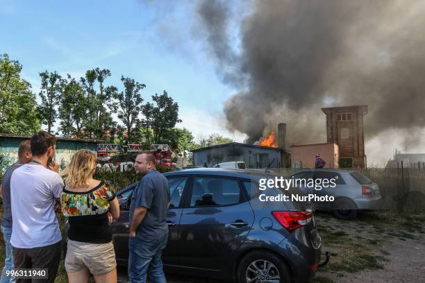 Firefighters in action are seen in Gdansk, Poland on 11 July 2018 Giant fire of the car repair garage, blowed-up on Thursday afternoon, just few...