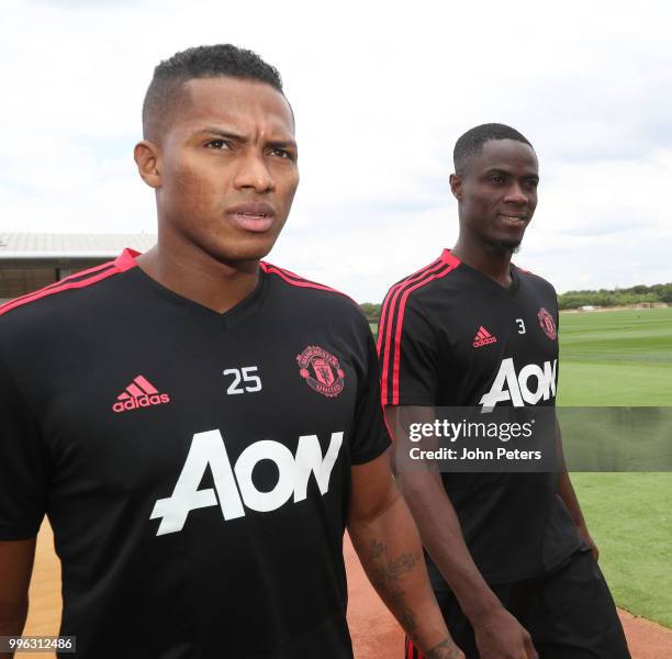 Antonio Valencia and Eric Bailly of Manchester United walk out ahead of a first team training session at Aon Training Complex on July 11, 2018 in...