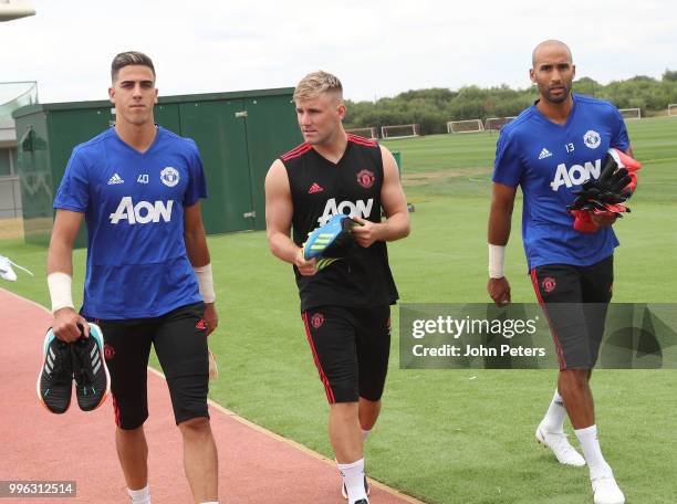 Joel Pereira and Luke Shaw of Manchester United walk out ahead of a first team training session at Aon Training Complex on July 11, 2018 in...