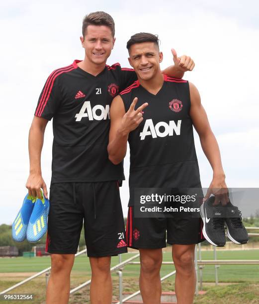 Ander Herrera and Alexis Sanchez of Manchester United walk out ahead of a first team training session at Aon Training Complex on July 11, 2018 in...