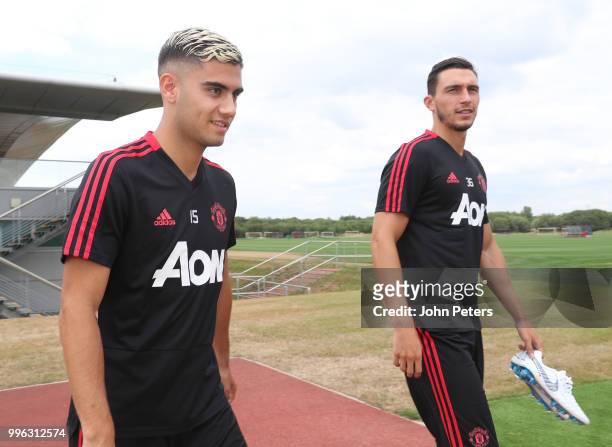 Andreas Pereira and Matteo Darmian of Manchester United walk out ahead of a first team training session at Aon Training Complex on July 11, 2018 in...