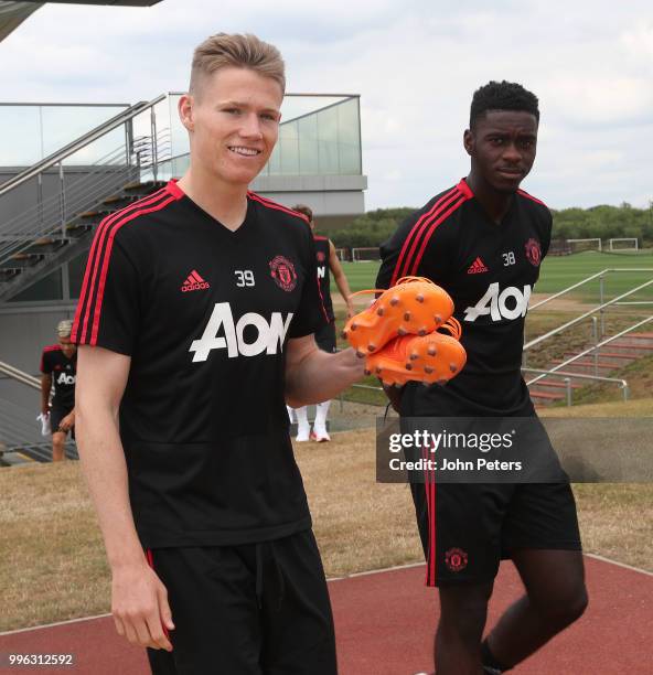 Scott McTominay and Axel Tuanzebe of Manchester United walk out ahead of a first team training session at Aon Training Complex on July 11, 2018 in...