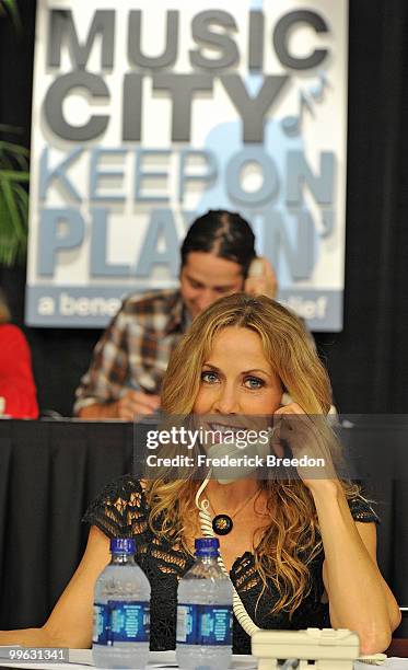 Singer Sheryl Crow works the phone bank during the "Music City Keep on Playin'" benefit concert at the Nashville Convention center on May 16, 2010 in...