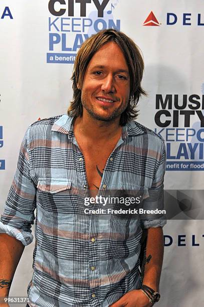 Country singer Keith Urban poses after working the phone bank during the "Music City Keep on Playin'" benefit concert at the Nashville Convention...