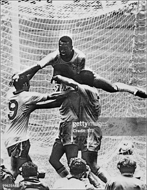 Brazilian forward Pele celebrates with his teammates Tostao, Carlos Alberto and Jairzinho during the World Cup final between Brazil and Italy 21 June...