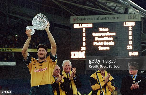 Australian captain John Eales holds up the Tom Richards Cup aloft after the third and final Test Match played between the British and Irish Lions and...