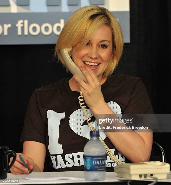 Country singer Kellie Pickler works the phone bank during the "Music City Keep on Playin'" benefit concert>> at the Nashville Convention center on...