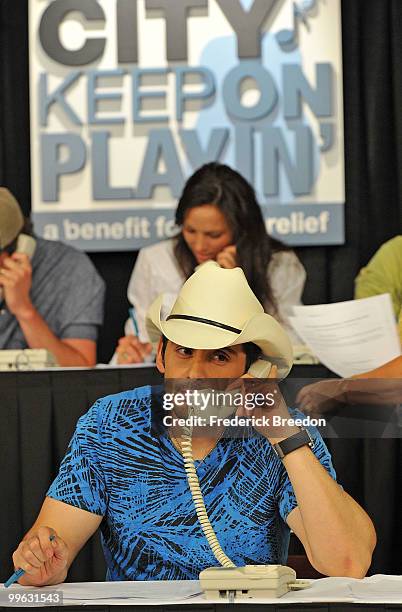 Country singer Brad Paisley works the phone bank during the "Music City Keep on Playin'" benefit concert at the Nashville Convention center on May...