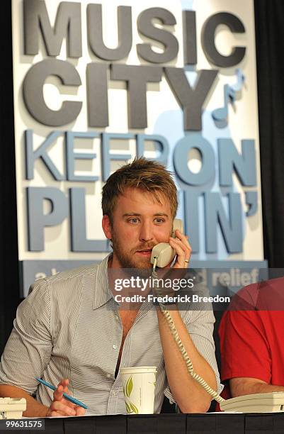 Country singer Charles Kelley, of the band Lady Antebellum, works the phone bank during the "Music City Keep on Playin'" benefit concert at the...