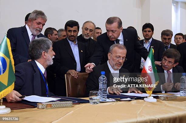 Brazilian President Luiz Inacio Lula da Silva and Iran's President Mahmoud Ahmadinejad stand next toTurkish Prime Minister Recep Tayyip Erdogan as he...