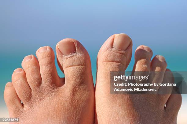 two resting lazy feet on a caribbean sky backdrop - matanzas stockfoto's en -beelden