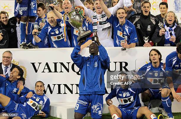 Gent's team celebrates with Senegal's Mbaye Leye holding the cup after they won 3-0 the final game of the Belgian Cup against Cercle Brugge on May 15...