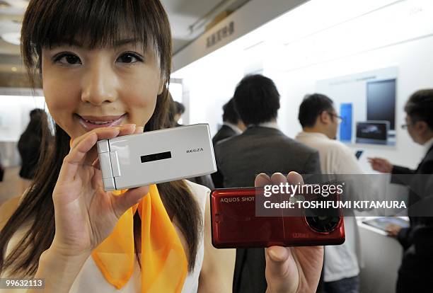 Model shows off KDDI's brand, AU's new 2010 summer models of moble handsets during their press preview in Tokyo on May 17, 2010. KDDI introduced...