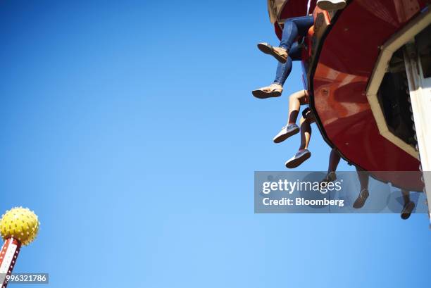 People sit on an amusement ride at Luna Park in Coney Island in the Brooklyn Borough of New York, U.S., on Saturday, July 7, 2018. Bloomberg is...