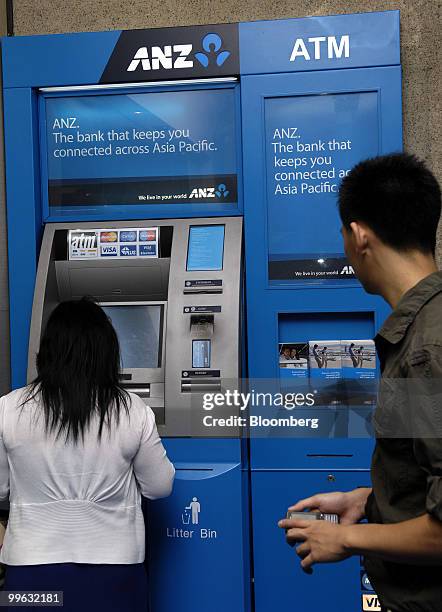 Customers use the automated teller machines at the newly opened flagship branch of Australia & New Zealand Banking Group Ltd. In the central business...